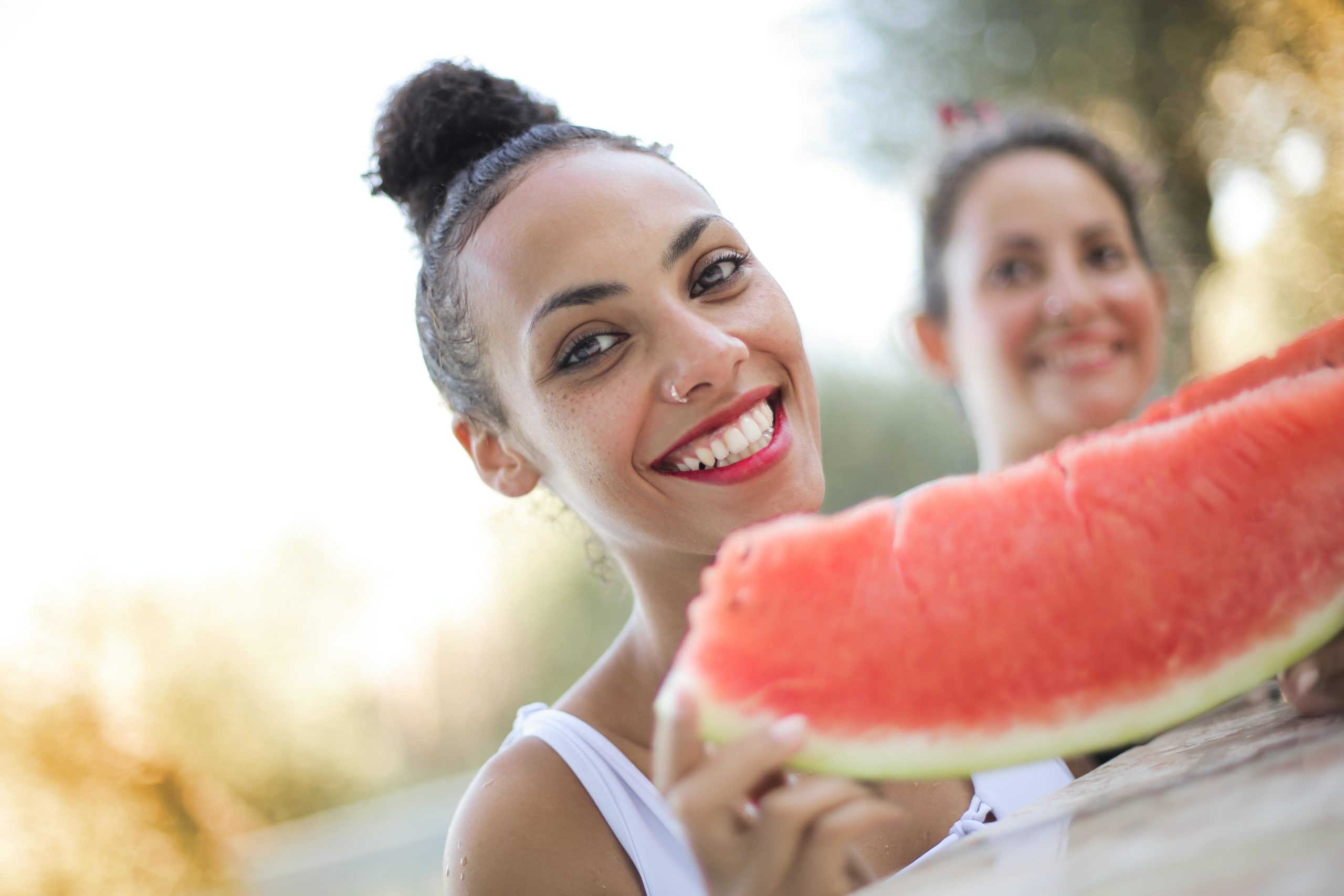 Smiling woman eating watermelon