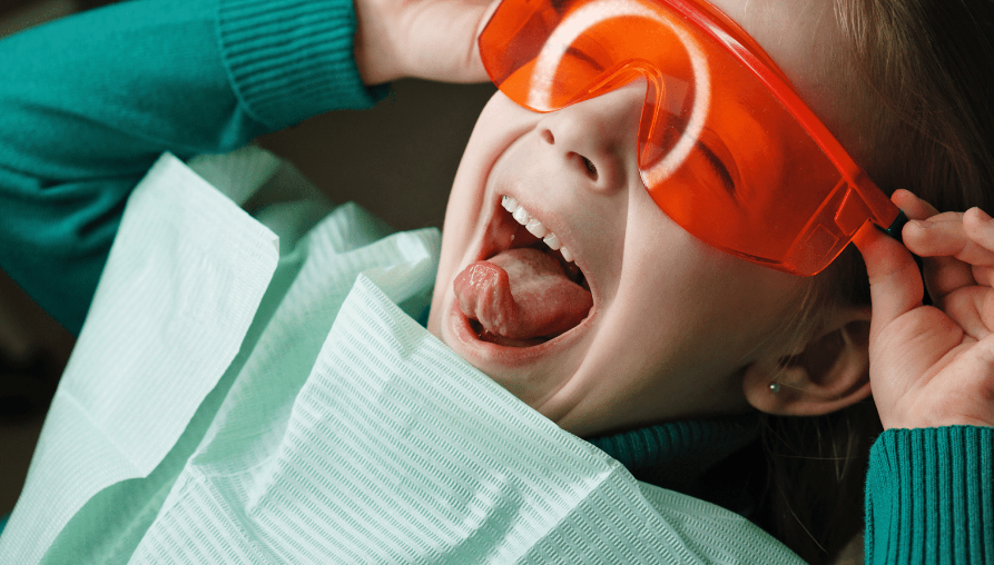 Happy Child getting Dental Xrays with orange glasses on