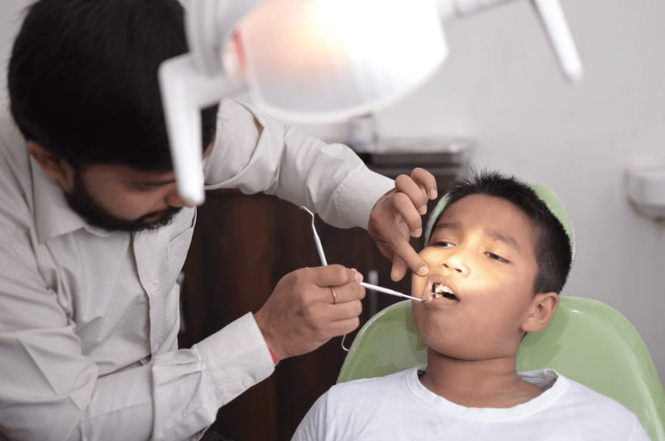 child at dentist getting dental sealants