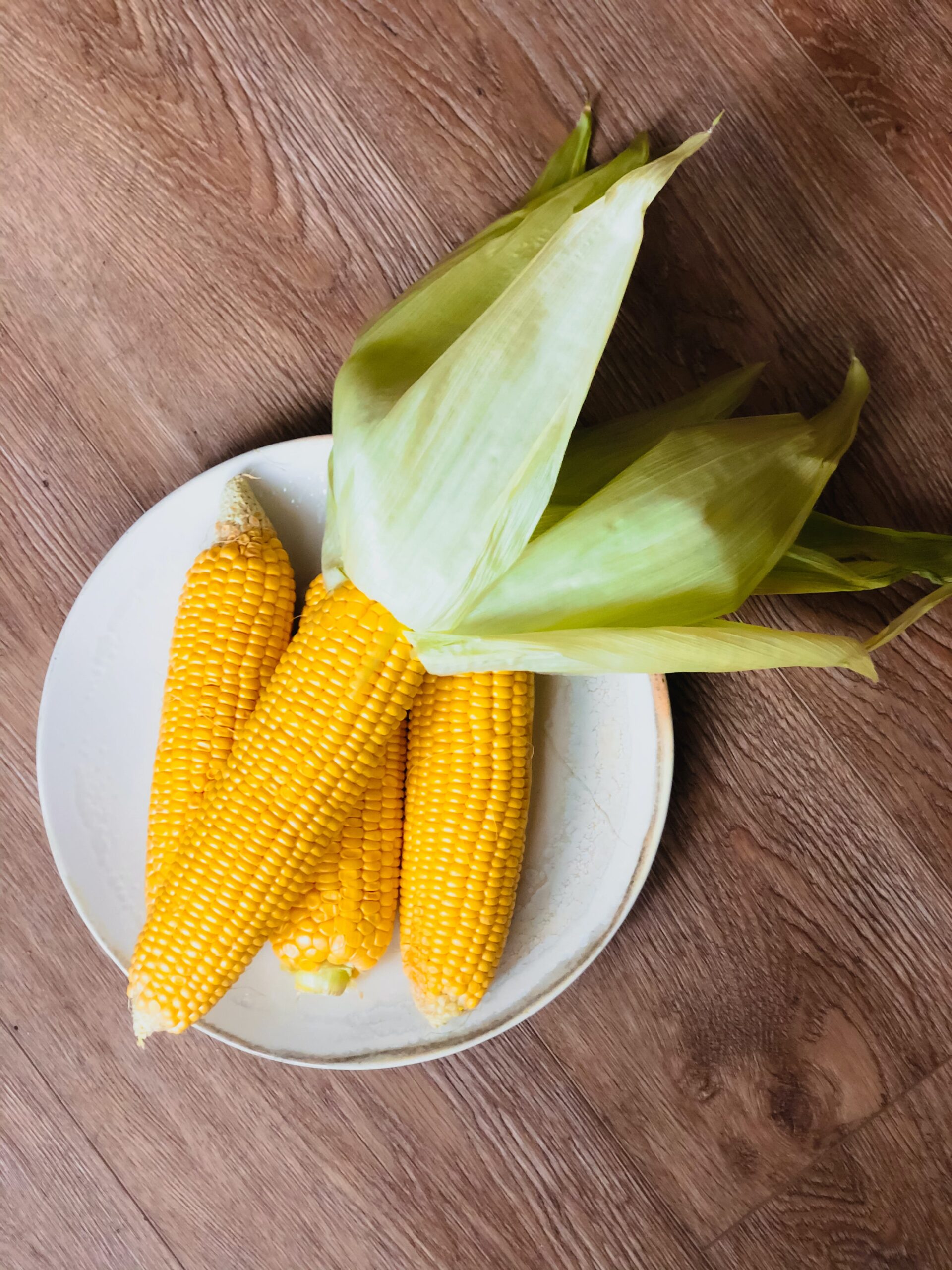 Yellow corn on the cob on a plate