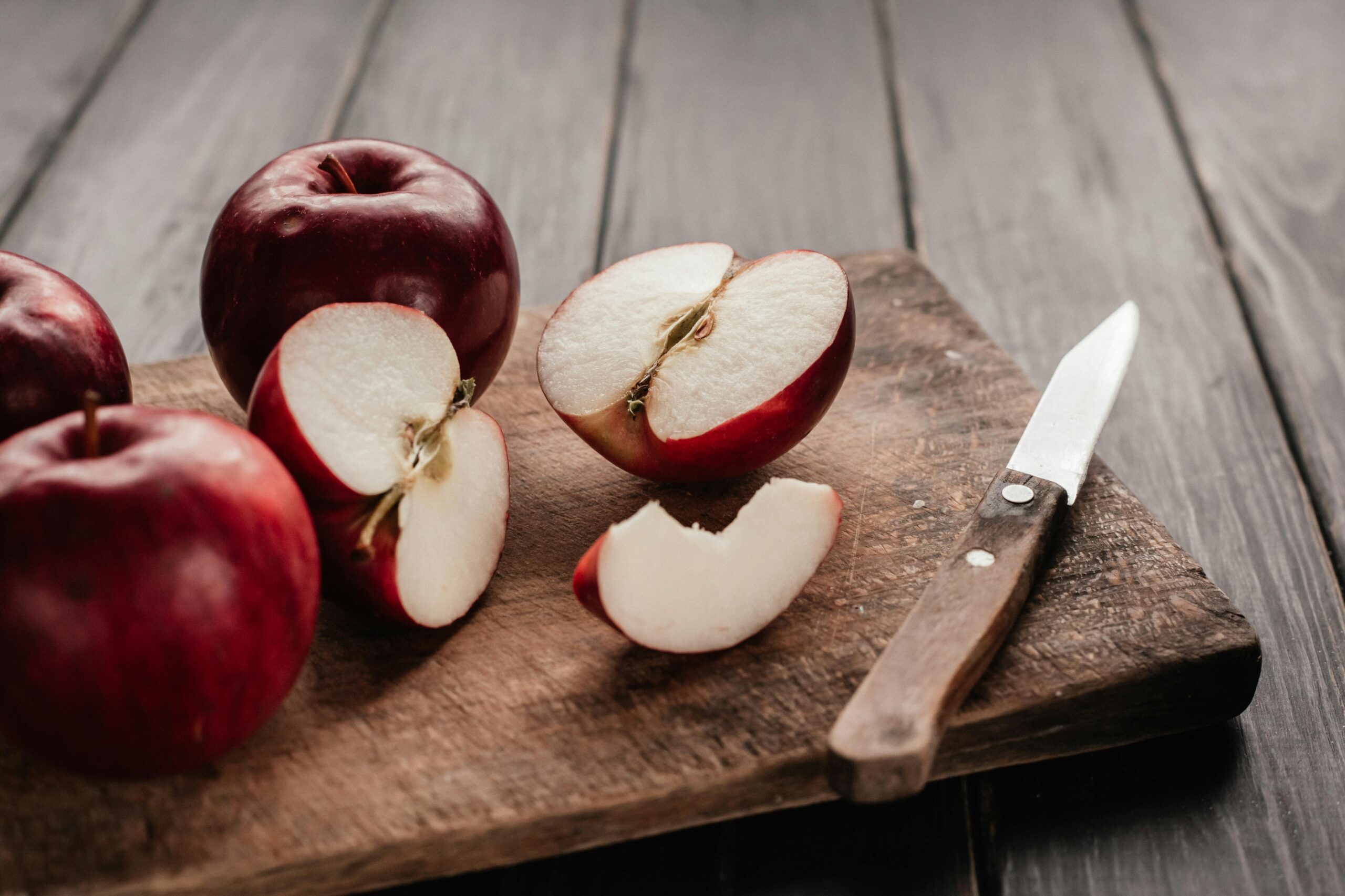 sliced red apples on a chopping board