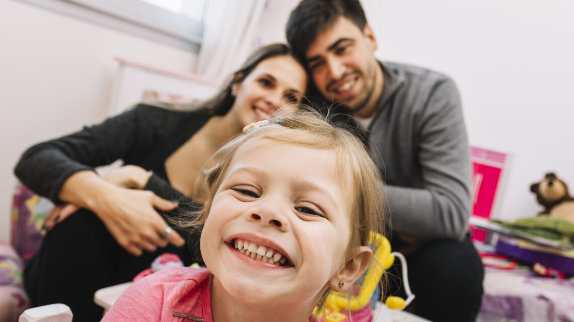 Close-up of a happy girl in front of her parents