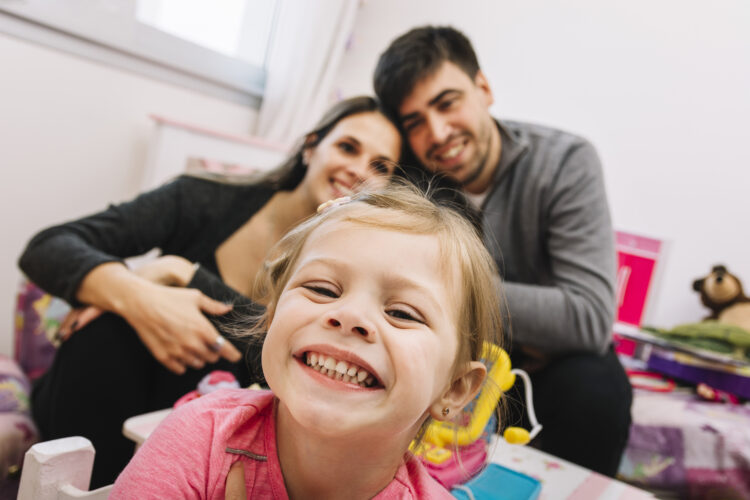 Close-up of a happy girl in front of her parents