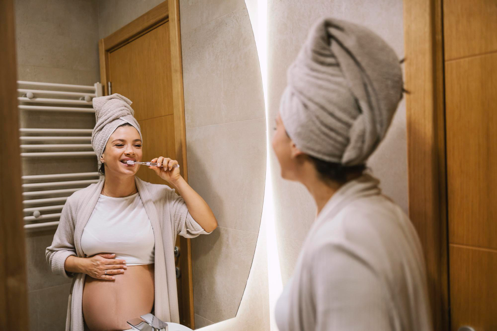 A pregnant woman is brushing her teeth and doing night routine before bed