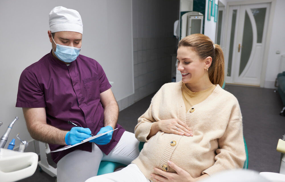 Pregnant woman brushing her teeth in a bathroom