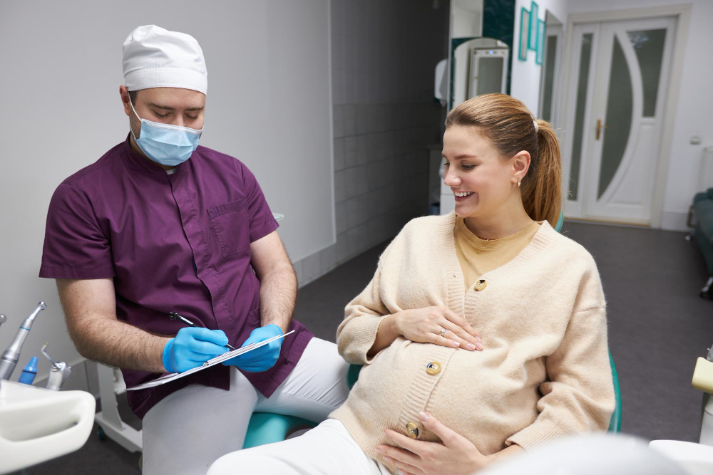 Pregnant woman brushing her teeth in a bathroom